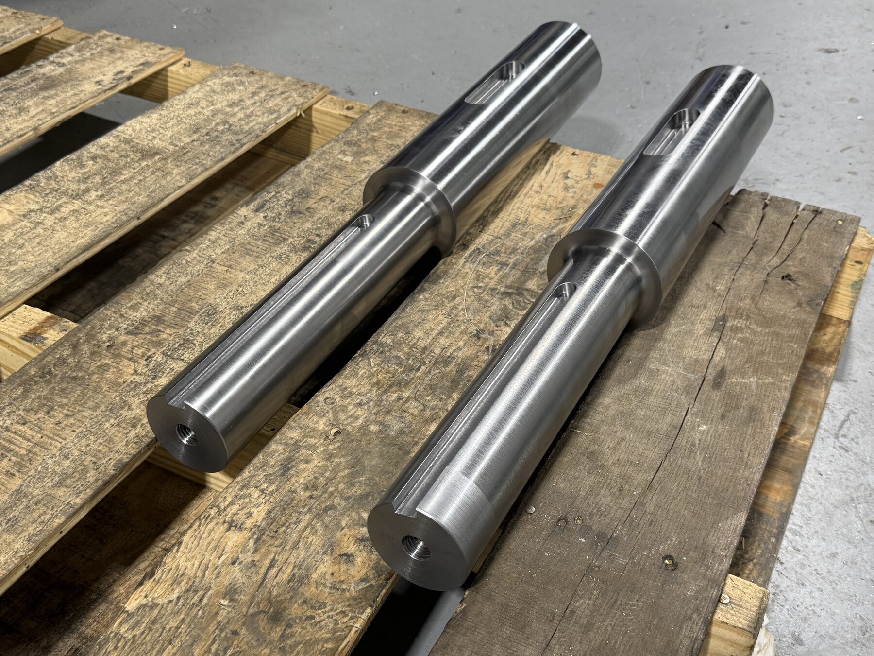 Pair of finished axles staged on a pallet